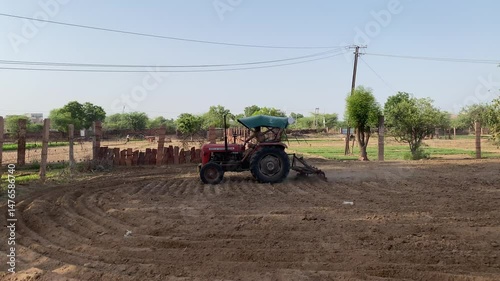 Cultivating field With Tractor in a indian farmland, Tractor in field, Preparation for planting. Indian Farmland, Farmer, Agriculture, Indian Agriculture field.