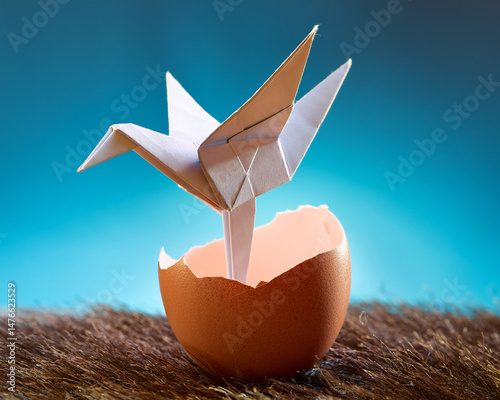 The irrepressible origami bird that emerges from an egg to symbolize a business startup or development breakthrough represents emerging potential and success.