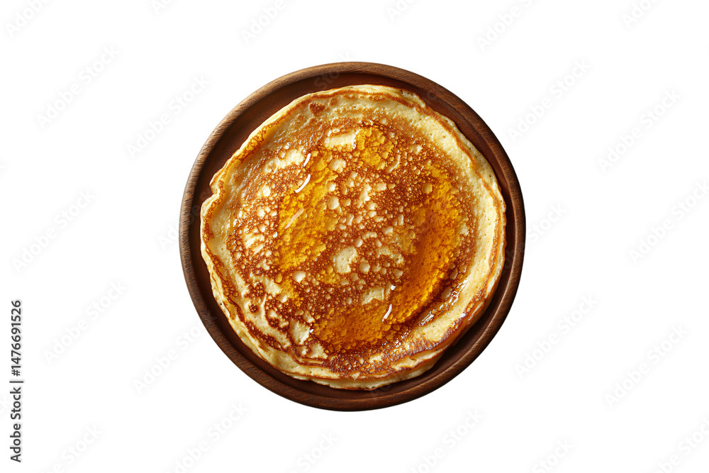 A large pancake soaked in syrup, placed on wooden plate, evoking warmth and rustic breakfast comfort, isolated on a transparent background