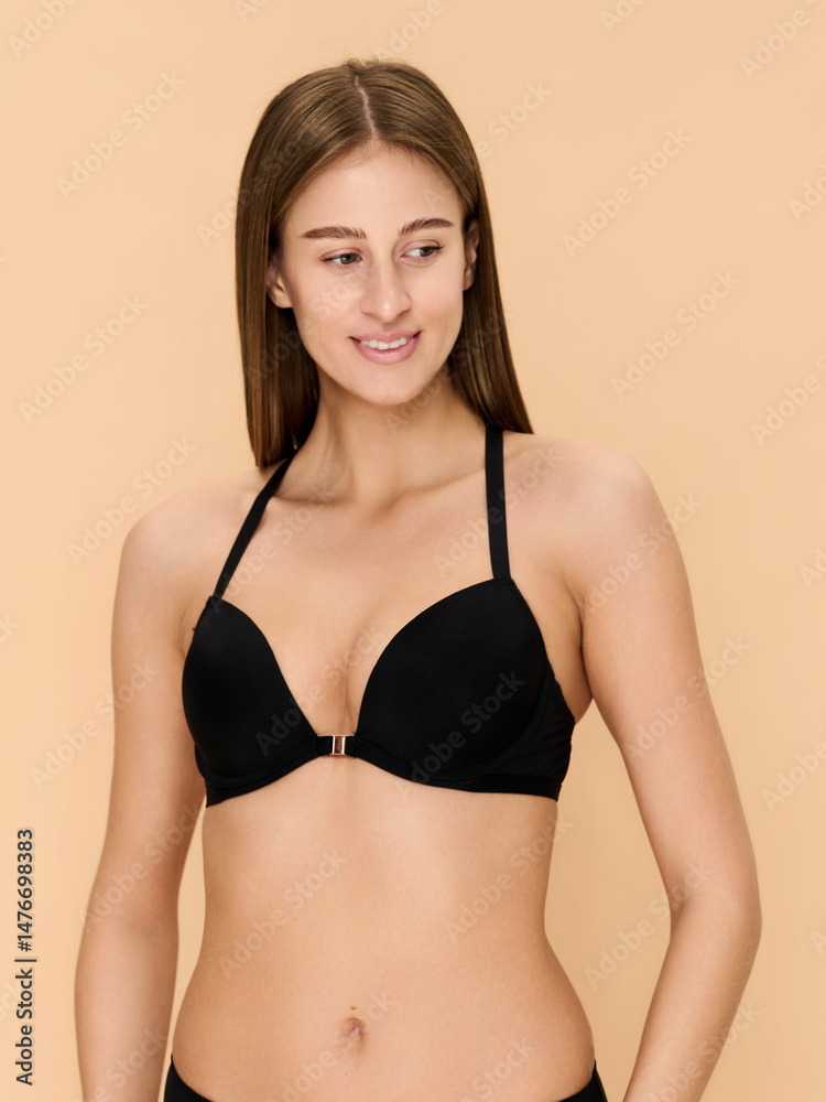 Girl model in lingerie posing on beige studio background. Girl model in lingerie posing on beige studio background.