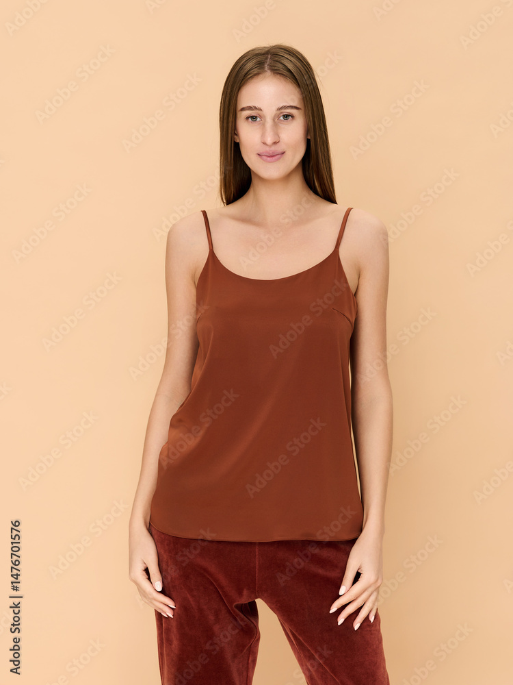 Obraz premium Girl model in lingerie posing on beige studio background.