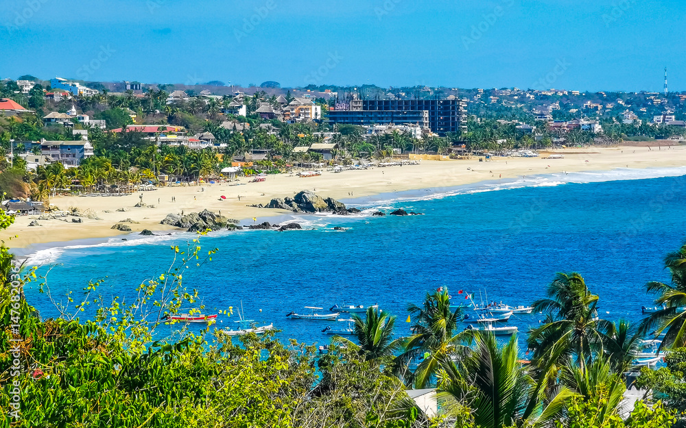 Fototapeta premium Sun beach sand surfer waves palms in Puerto Escondido Mexico.