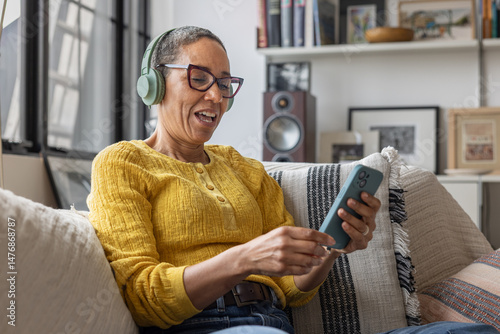 Mature woman learning a new language using a smartphone