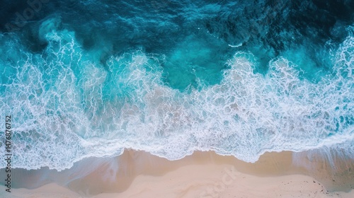 A drone shot of a coastline with summer waves crashing