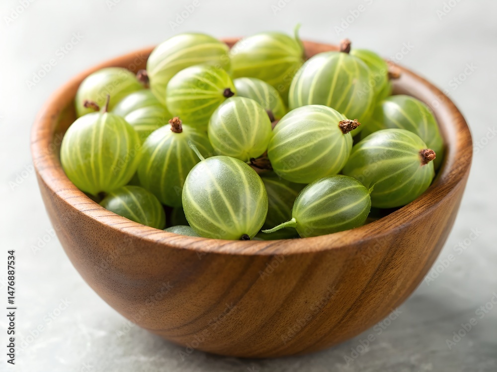 Fresh green gooseberries in a rustic wooden bowl with natural lighting highlighting their translucent skin and vibrant color Fresh green gooseberries in a rustic wooden bowl with natural lighting highlighting their translucent skin and vibrant color