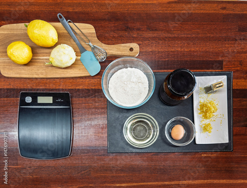 Baking essentials with lemons and ingredients on a table photo