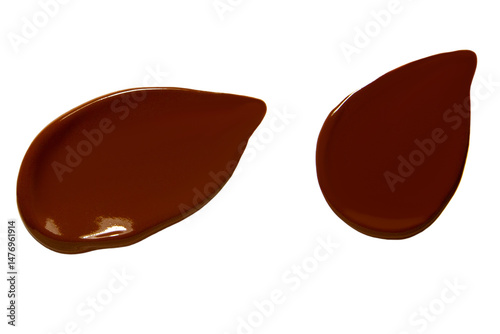  Two smears of dark foundation cream on an empty background.