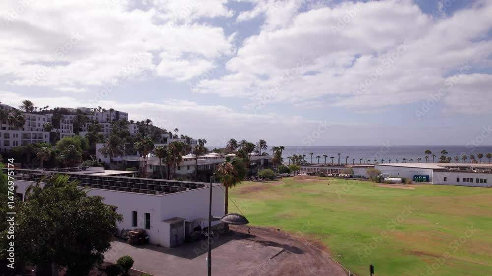 Aerial View of Golf Course, Hillside Houses and Ocean Horizon in Fuerteventura Aerial View of Golf Course, Hillside Houses and Ocean Horizon in Fuerteventura