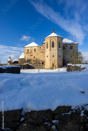 Krasiczyn Castle covered by snow during sunny winter day