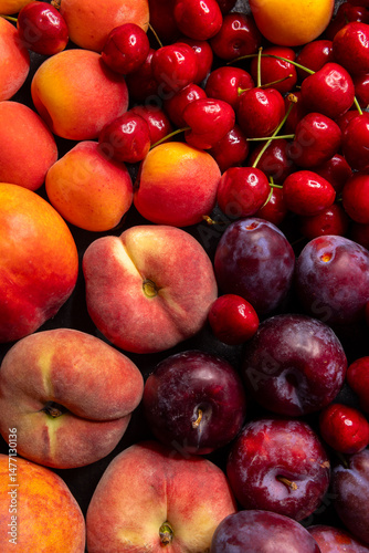 Fototapeta Naklejka Na Ścianę i Meble -  Fresh peaches, plums, cherries and apricots creating a colorful summer background