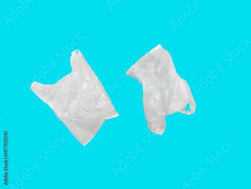 The image shows two transparent plastic bags floating against a bright blue background. Both bags appear crumpled and semi-transparent