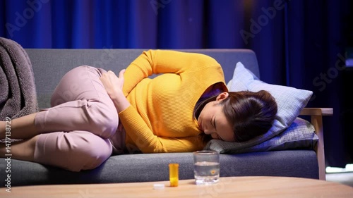 Video 4K Resolution of Asian woman with hands squeezing belly having painful stomach ache or period cramps, feeling abdominal menstrual pain, Abdominal pain, gastritis, diarrhea, indigestion