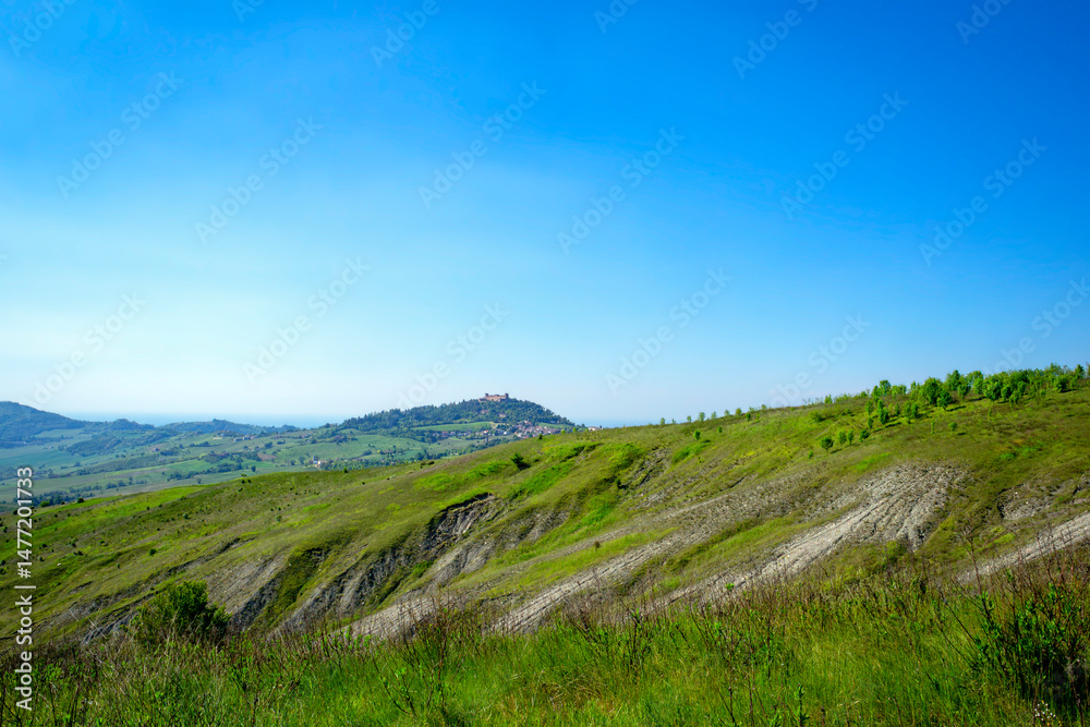 Naklejka premium Springtime panorama of the hills range of Oltrepo Pavese. Is a winery area between Lombardy, Emilia and Piedmont Regions (Northern Italy), mainly in the Pavia Province.