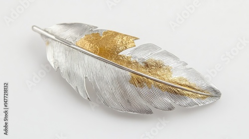 Metal feather brooch featuring brushed silver and polished gold textures against white background
