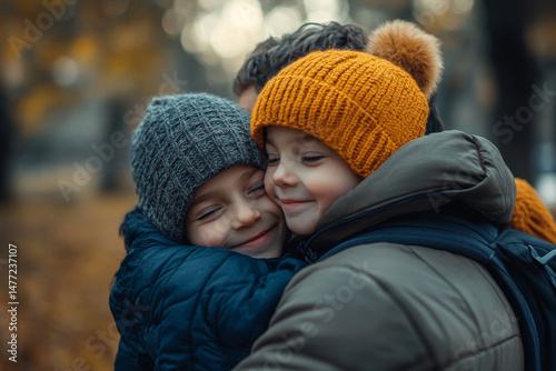 happy father hugging adorable smiling little son in park