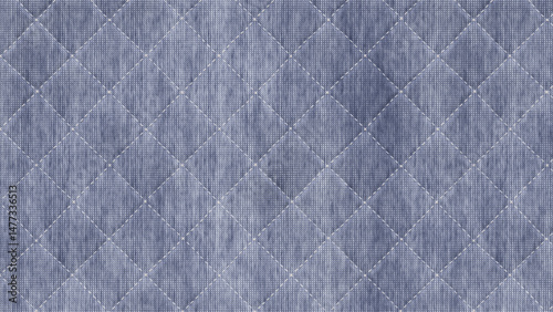 Close up of blue quilted fabric with diamond pattern and stitch lines