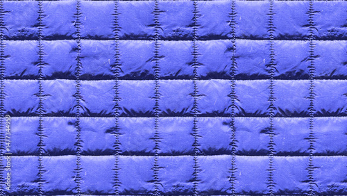 Close up of a quilted fabric in blue with stitching detail pattern