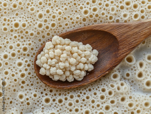Close-up of Kefir Grains on Wooden Spoon with Fermented Milk Background Macro Food Photography