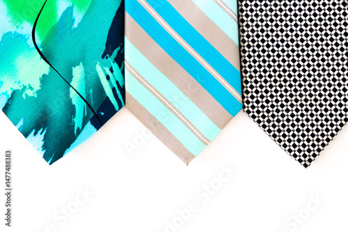 The tips of three ties on a white background