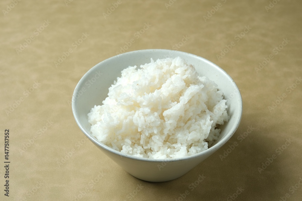 Nasi putih or rice in bowl, served on brown background. empty space for text. Food background Nasi putih or rice in bowl, served on brown background. empty space for text. Food background