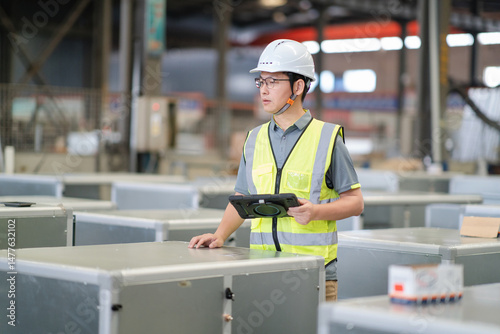 asian male engineer woking on digital tablet in factory with  Industrial fan impeller photo