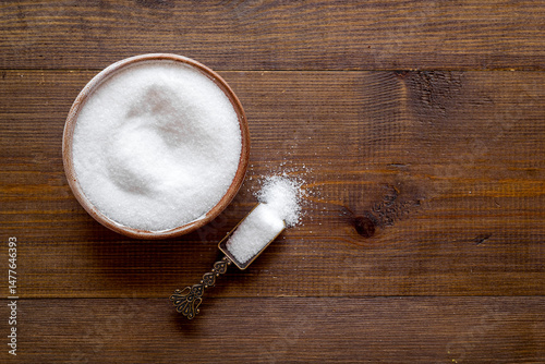 Finely grinding of edible sea salt, close-up. Maintaining acid-base balance concept photo