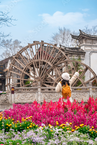 Photography Young female tourist enjoys traveling at Lijiang Ancient Town, The famous touris