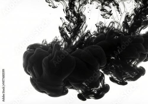 High-speed micro-shot of black ink dispersing in clear water.
