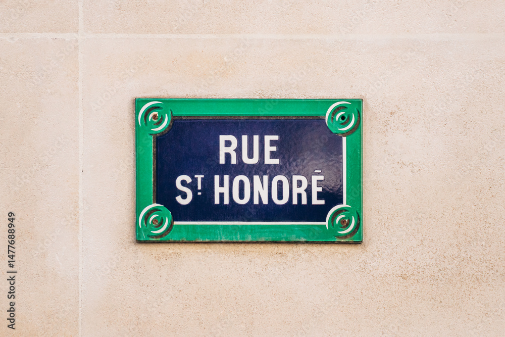 Obraz premium Rue Saint Honore street sign, 1st arrondissement, blue and green plaque on beige wall