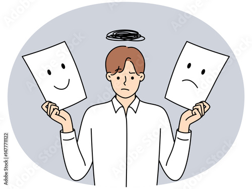 Man holds two sheets of paper with different emotions symbolizing mood swings