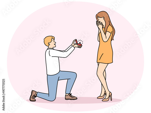 Man in love kneeling down, gives ring to beloved, offering to marry and play wedding