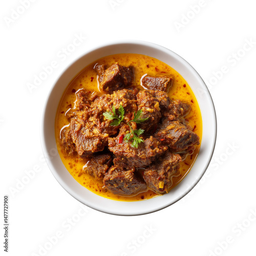 A savory dish of rendang dish tender beef chunks simmered in a rich, aromatic sauce, garnished with fresh herbs for added flavor.