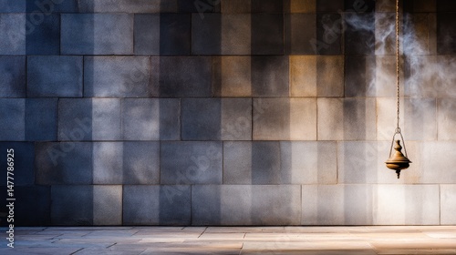 A solitary hanging lantern casts soft shadows on a textured stone wall in a tranquil setting