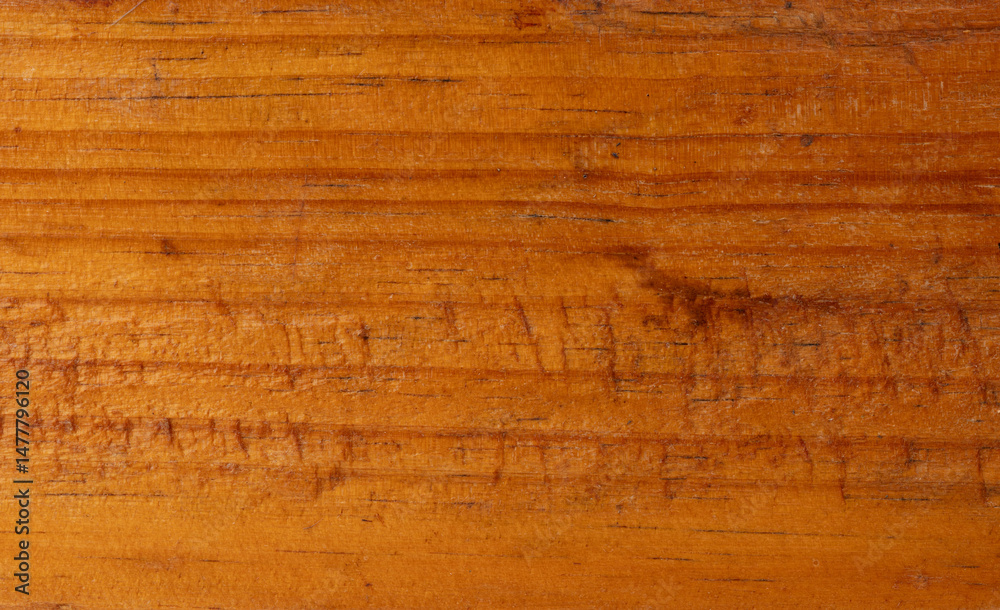 Wooden surface with rich texture showcasing natural grain details in warm tones