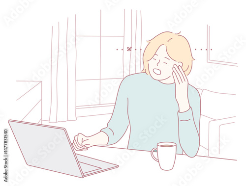 A person showing signs of stress and anxiety while working from home on their laptop with a cup of coffee