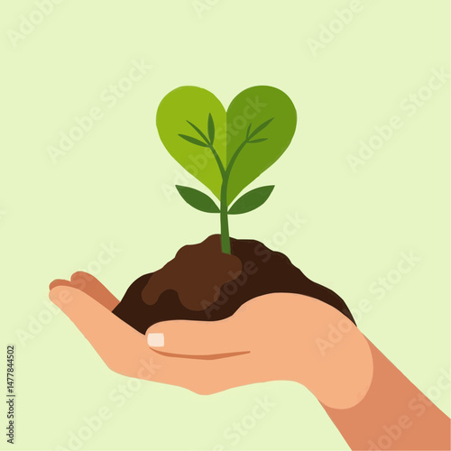 Green plant sprouting from soil held in hand against light background  