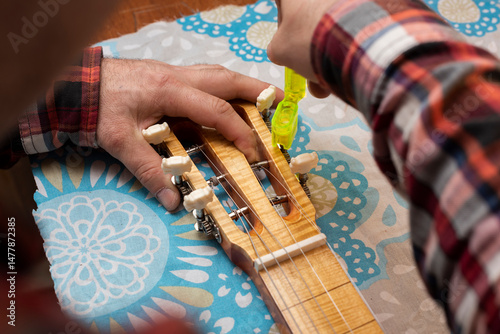 The guitar master pulls the strings on the guitar