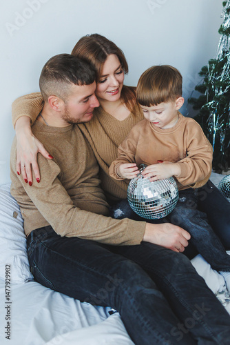 Obraz na płótnie Family Bonding Moments A Warm and Joyful Celebration shared with a Loving Child and Parents, all dressed in Cozy Sweaters, create memories filled with laughter and happiness during the holidays w salonie