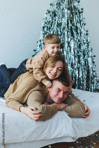 Obraz na płótnie A Joyful Family Holiday Moment A Parent and Child Are Delightfully Posed Together Against a Beautiful and Festive Holiday Backdrop, Capturing the Essence of the Celebration and Togetherness w salonie