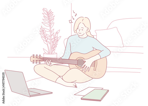 In her cozy home, a woman joyfully plays her guitar while being inspired by various online digital learning resources
