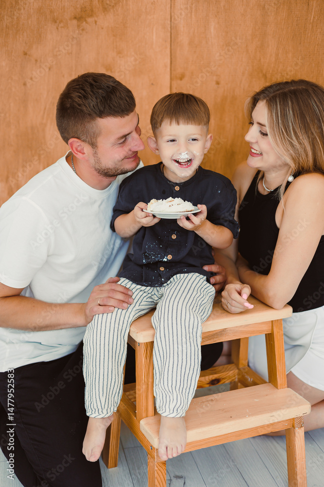 A Joyful Family Portrait Parents and Their Child Celebrating Together in a Cozy Atmosphere, Capturing Precious Moments of Love and Togetherness in a Happy and Emotional Family Setting