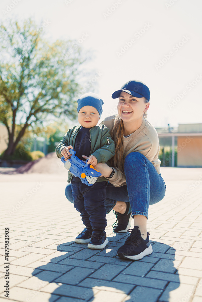 Experience the pure joy of outdoor moments where a loving mother and her cheerful child fully embrace the beauty of life under the bright and warm sunshine, creating lasting memories together