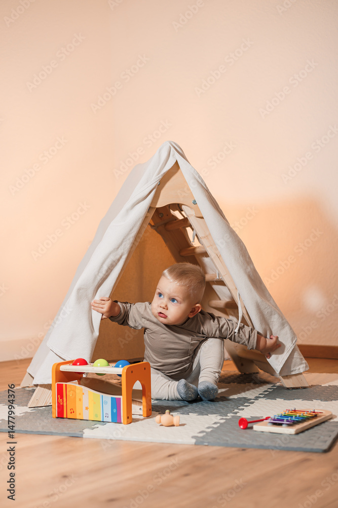 A playful baby explores a cozy indoor tent filled with colorful musical instruments, stimulating imagination and encouraging fun, carefree play along with learning and entertainment for children