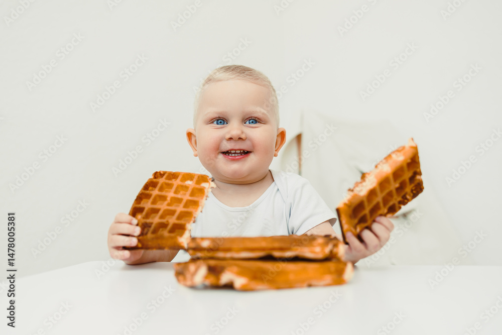 A Joyful and Excited Toddler Relishing Every Bite of Delicious Waffles While Sitting at the Table Capturing Precious Moments of Pure Childhood Delight and Happiness, Full of Innocence and Fun