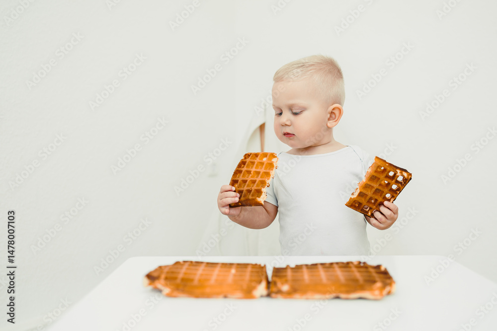 A Curious Toddler Holding Waffle Pieces This captures a delightful and fun moment filled with exploration and taste, showcasing the innocence and joy of childhood as they enjoy their tasty snacks