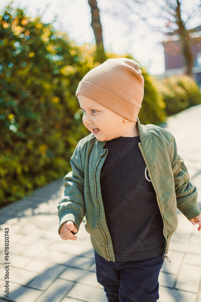A joyful child happily strolling outdoors in a stylish, vibrant outfit, embracing the adventure of youthful playfulness in a beautiful urban park filled with greenery and spaces for fun