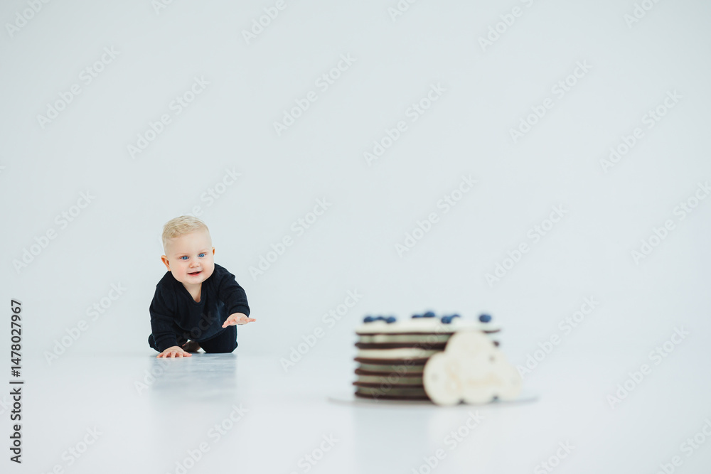 An adorable baby is crawling eagerly towards a delicious and beautifully decorated cake placed on a minimalist white surface, radiating sweetness and charm, promising a delightful treat for all
