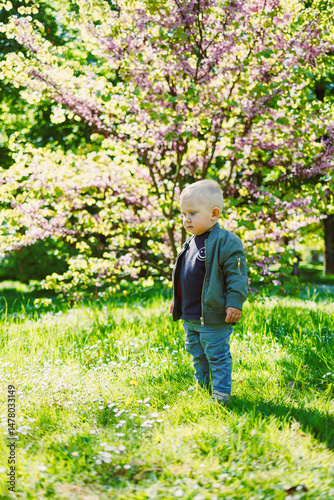 A cheerful toddler joyfully explores a vibrant spring landscape filled with blooming trees and the enchanting colors of nature, embodying the essence of childhood innocence and wonder