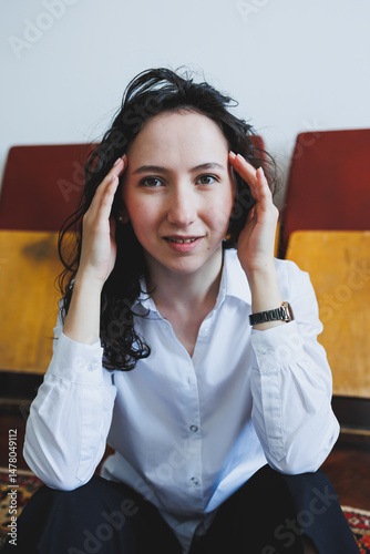 Obraz na płótnie A young woman with curly hair is conveying a range of emotions in a cozy and inviting indoor setting, creating a charming atmosphere filled with beauty and genuine expression of her feelings w salonie