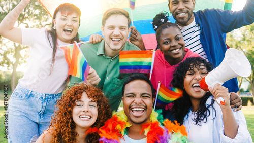 Diverse group of people celebrate gay festival in pride month party. Happy LGBT community holding rainbow flags